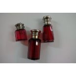 A Victorian ruby red scent bottle, having embossed silver hinged lid, by Charles May,