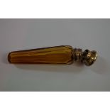 An amber tapered cut glass perfume flask, having gilt metal hinged cap, 10cm.