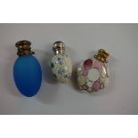 Three various metal capped perfume flasks.