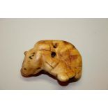 A Japanese carved stag antler netsuke of a recumbent ox, probably 18th century, 6cm wide.