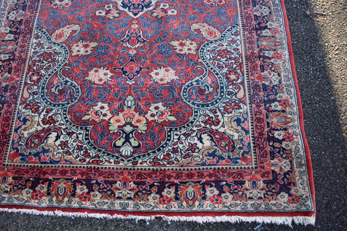 A Persian Saruq rug, having central medallion on red floral field. - Image 3 of 5