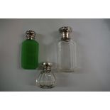 Two silver lidded scent bottles; together with a green glass bottle.