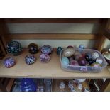 A collection of glass paperweights; together with hardstone eggs and similar.