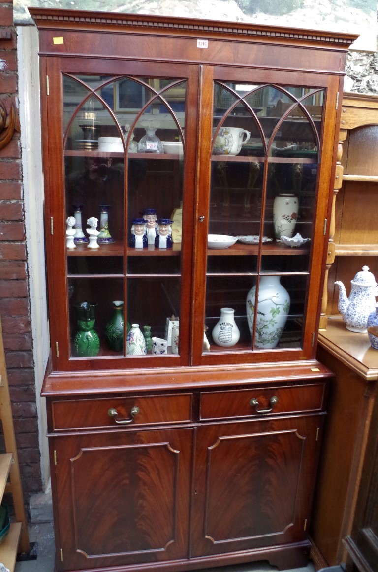 A reproduction mahogany bookcase, 99cm wide.