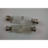 Two cut glass double ended perfume bottles, having metal caps.