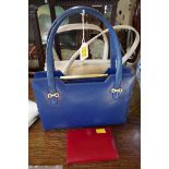 A vintage blue leather Gucci handbag; together with a cream leather example;