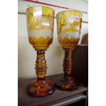 A pair of 19th century Bohemian amber stained and engraved oversized goblets, 38cm high,