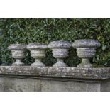 Garden urns/Planters: A set of four composition stone urns, early 20th century, 38cm.; 15ins high