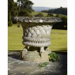 Garden Urns/Planters: A composition stone basket planter on stand, 2nd half 20th century, 107cm.; 42