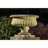 Garden Urns/Planters: A carved limestone urn, modern, 51cm.; 20ins by 64cm.; 25ins diameter