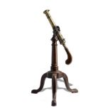 A small bronze Swivel cannon with swivel mounts18th/19th centurywith replaced mahogany handle now