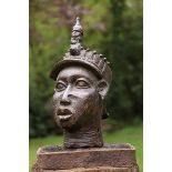 A Tribal Benin style bronze head 47cm.; 18½ins high by 24cm.; 9½ins wide by 28cm.; 11ins deep