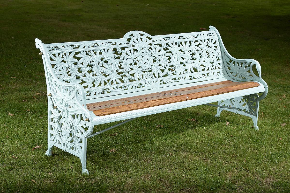 Garden Seat: A Coalbrookdale Passion Flower pattern cast iron seat circa 1870stamped with