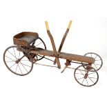 An Edwardian child's Go Kart,early 20th centurywith wooden frame and iron mechanism and wheels 122cm