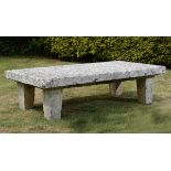 Garden Furniture: A substantial carved limestone rectangular table on four supports,60cm high by