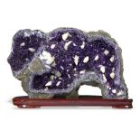 Minerals: An amethyst and calcite specimen of exceptional deep colour with wooden stand Uraguay 65cm