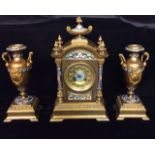 A 19TH CENTURY BRONZE ORMOLU AND CHAMPLEVE ENAMEL GARNITURE CLOCK SET The architectural shape with a