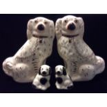 STAFFORDSHIRE, A PAIR OF EARLY 20TH CENTURY POTTERY FIGURES OF SPANIELS With gilt decoration,