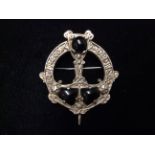 A 20TH CENTURY HALLMARKED SILVER AND BLACK RESIN CELTIC STYLE CIRCULAR BROOCH With Celtic design