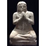 AN ANTIQUE INDIAN CARVED STONE STATURE OF THE GODDESS SHIVA Seated in lotus position, with elongated