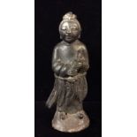 AN ORIENTAL CAST IRON FIGURE OF A SCHOLAR Wearing long flowing robes and holding a scroll. (approx h