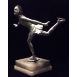 A 20TH CENTURY CENTURY ART DECO SPELTER FIGURINE A lady ice skater, cold painted with silver body,