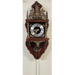 A 20TH CENTURY DUTCH STRIKING WALL CLOCK Mounted with a brass figure of the god Atlas, holding aloft