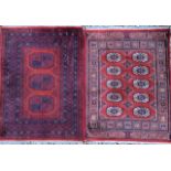 LAHORE, AN ANTIQUE WOOLEN RUG Having two rows of oval lozenges with a single row of hooked guls to