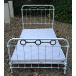 A VICTORIAN WHITE PAINTED IRON AND BRASS BED With cast iron shell and brass ring decoration. (h