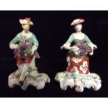 A RARE PAIR OF 18TH CENTURY DERBY PORCELAIN FIGURES Representing 'Autumn', seated wearing green