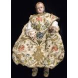 A RARE AND UNUSUAL 18TH CENTURY POURED WAX DOLL Relief moulded hair and dark glass eyes, wearing a