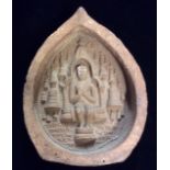 AN ANTIQUE INDIAN TERRACOTTA VOTIVE PLAQUE A seated Buddha in a temple, after a similar plaque
