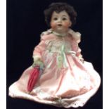 ARMAND MARSEILLE, AN EARLY 20TH CENTURY GERMAN BISQUE PORCELAIN DOLL Having brown opening eyes and