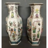 A PAIR OF CHINESE OCTAGONAL VASES Having foliate and applied decoration on a pale blue ground with a