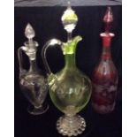 A VICTORIAN GREEN GLASS BULBOUS CLARET JUG With a clear glass handle and foot rim, together with a