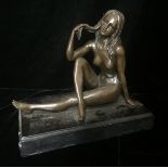 A BRONZE SCULPTURE OF A FEMALE NUDE Seated in a nonchalant position. (h 19cm)