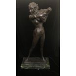 AFTER ESAKY, A BRONZE SCULPTURE OF A SEMI NUDE FEMALE Getting dressed, raised on a green marble