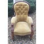 A VICTORIAN MAHOGANY FRAMED SPOONBACK ARMCHAIR CHAIR In mustard velvet button back upholstery.