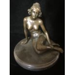 A BRONZE SCULPTURE OF A FEMALE NUDE Seated with hair tied back, raised on a black marble