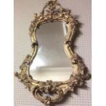 A 19TH CENTURY GILT GESSO KIDNEY FORM MIRROR