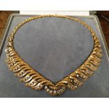 BOUCHERON, A CIRCA 1960 18CT GOLD AND DIAMOND NECKLACE Designed as a tapering articulated collar