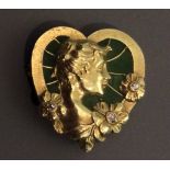 AN ART NOUVEAU 14CT GOLD, PLIQUE À JOUR AND DIAMOND HEART FORM BROOCH With a female head in