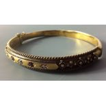 A VICTORIAN 15CT GOLD, DIAMOND AND RUBY BANGLE Set with three round cut diamonds interspersed with