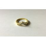 A HALLMARKED 18CT GOLD AND DIAMOND SET WISHBONE RING The plain gold wishbone band inset to front