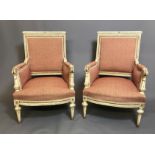 A PAIR OF 19TH CENTURY FRENCH ARMCHAIRS The finely carved wooden frames in a cream painted finish