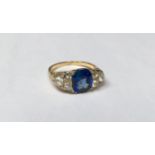 A LATE VICTORIAN 18CT GOLD, SAPPHIRE AND DIAMOND RING The cushion cut sapphire with three old cut