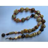 AN ANTIQUE GRADUATED ORIENTAL IVORY AND CORAL BEAD NECKLACE The graduated string of various Oriental