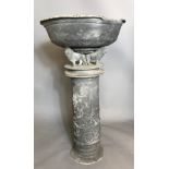 A 19TH CENTURY LEAD BIRD BATH The circular bowl centred with a classical scene and raised on lion