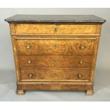 A 19TH CENTURY FRENCH BURR WALNUT COMMODE With black marble top over singe frieze and three long