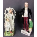 TWO 19TH CENTURY STAFFORDSHIRE POTTERY FIGURES OF THE DUKE OF WELLINGTON standing pose wearing a